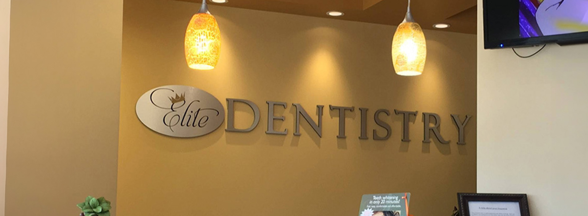 The image shows a modern dental clinic interior with various pieces of equipment, including a dental chair and an X-ray machine.